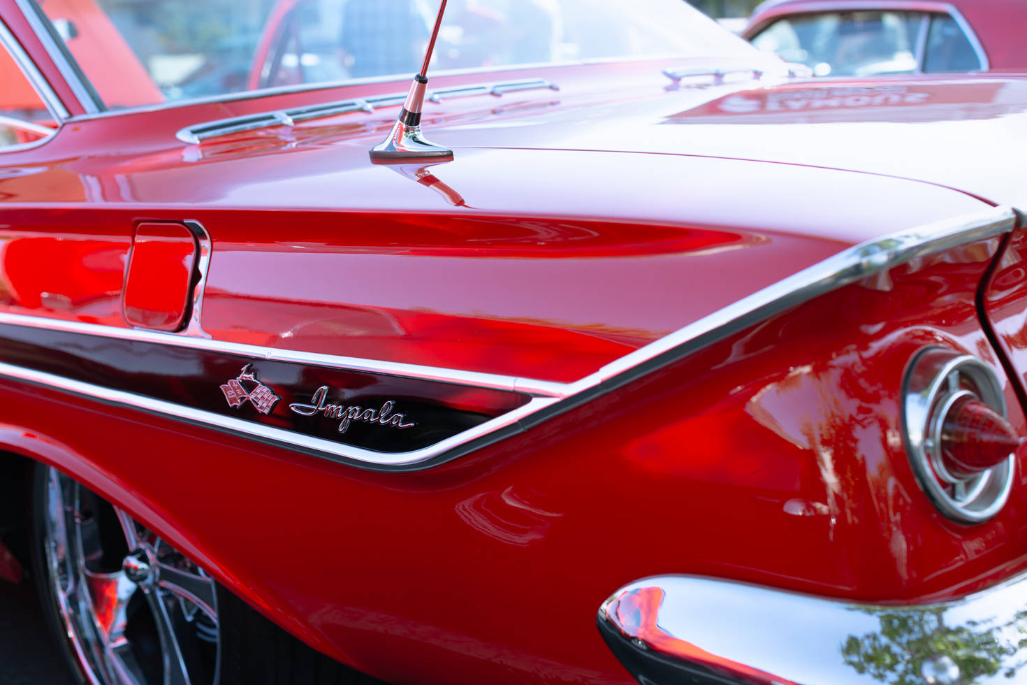 Reflections off of a red Chevy Impala.